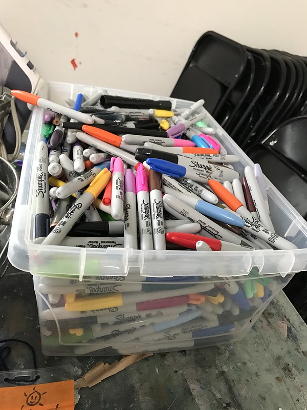 A container full of Sharpies.